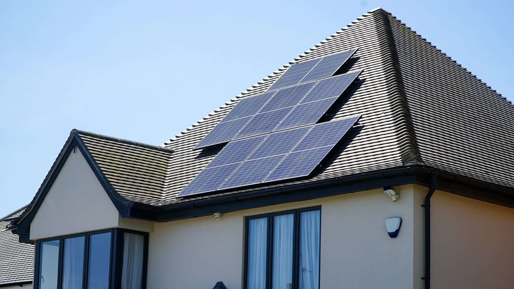 Home rooftop with solar panels under bright sunshine